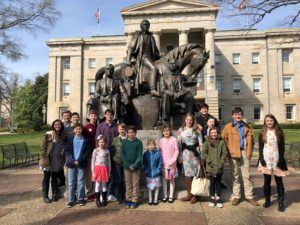 Forsyth County 4-H Trailblazers Teen 4-H Club in front of horse and rider statue