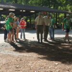 Forest Rangers teach youth participants how to measure a tree.