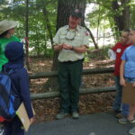 Forest Ranger teaches youth participants how to identify a tree.