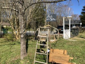 A ladder beside a hanging sign that reads "Thank You"