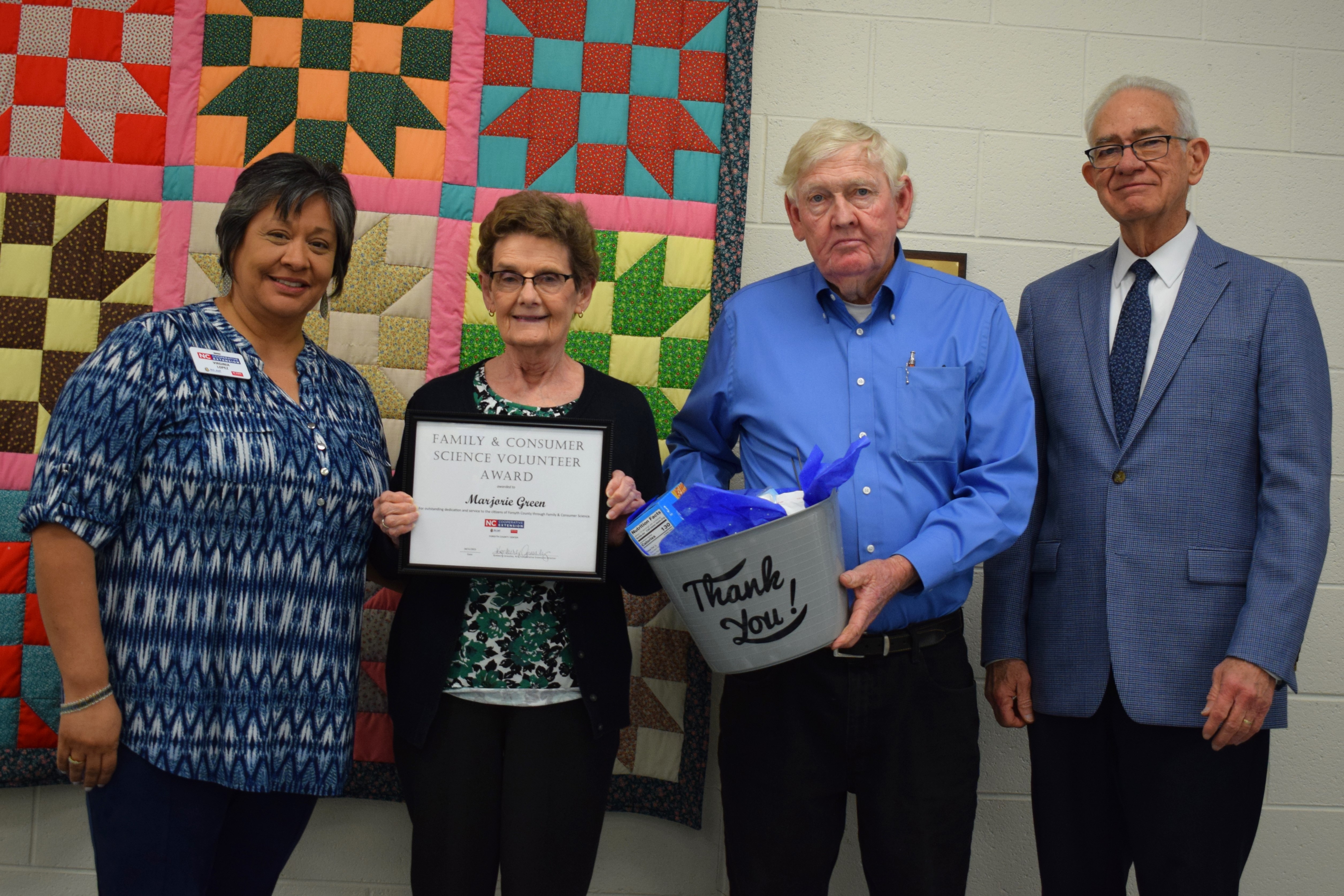 FCS Award Recipient, Marjorie Green, with FCS Agent, Virginia Lopez, and Forsyth County Commissioners Richard Linville and Dr. Don Martin