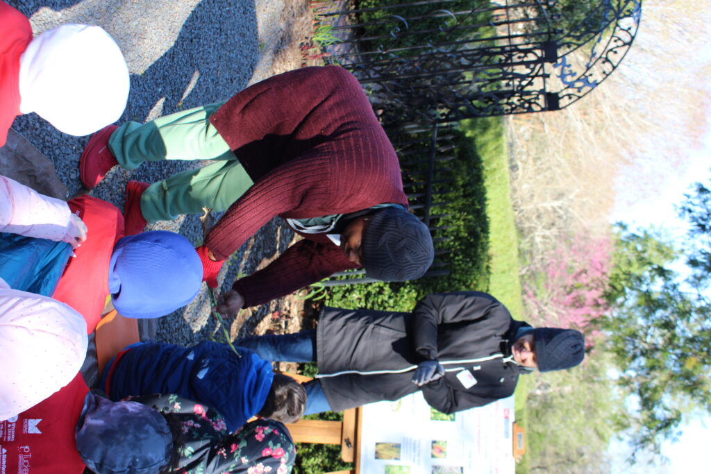 Instructor showing students a plant