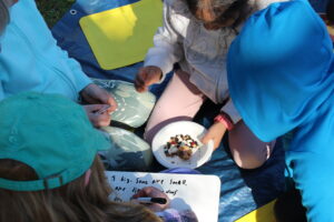 Students looking at seeds and taking notes